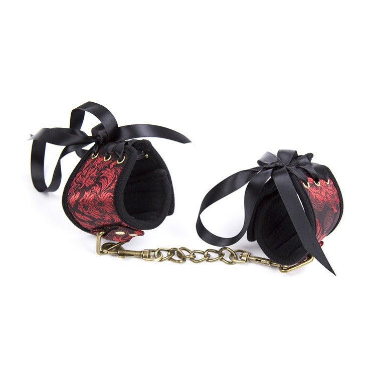 Elegant gold and red handcuffs for BDSM roleplay and restraint