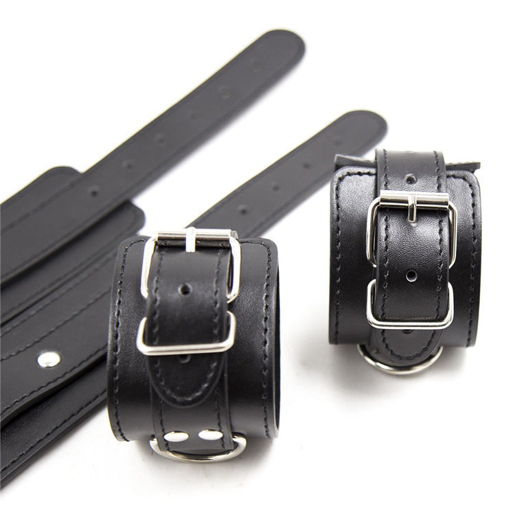 Leather cross handcuffs and foot cuffs for BDSM bondage