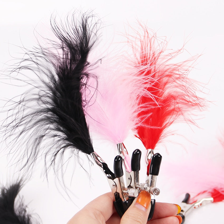 Sexy adjustable nipple clamps with feathers for fetish play.